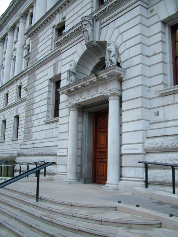 Stone facade and east entrance of HM Treasury at Government Offices Great George Street, Whitehall, London.